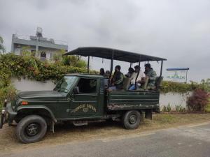 a group of people riding in the back of a truck at Hotel Lisne jungle land in Bharatpur