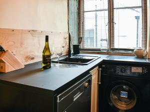 a bottle of wine sitting on a counter in a kitchen at Market Place View in Knaresborough