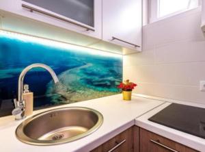 a kitchen counter with a sink and a sink at Villa Goldfield in Gradac +90 photos