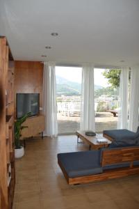 a living room with a flat screen tv and a couch at Casa William in Porto Azzurro