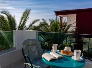 a table with two plates of food on a balcony at Villa Goldfield in Gradac