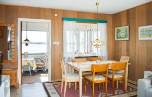 a kitchen and dining room with a table and chairs at Sommarstuga med strandtomt in Ronneby