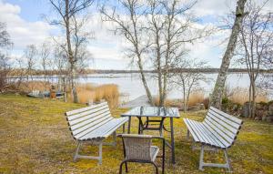 a table and two chairs and a table and a table and chairs at Sommarstuga med strandtomt in Ronneby