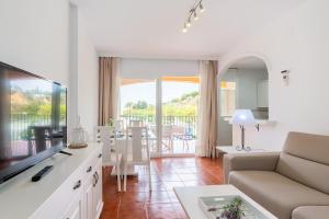 a living room with a couch and a table at Leo Islamar in Islantilla