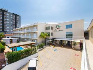 a large building with a swimming pool in front of it at Hotel do Feijão in Cachoeira Paulista