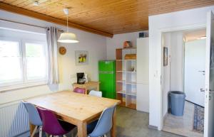 a dining room with a wooden table and chairs at Monteurwohnung bei Crailsheim Feuchtwangen in Fichtenau