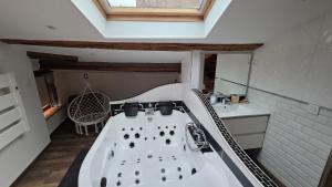 a bathroom with a bath tub in a attic at Loft Unique Romantique & Balnéothérapie in Riom