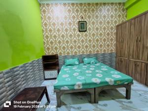 a bedroom with a bed with blue pillows at Vraja Kishori Sewa Dham in Vrindāvan