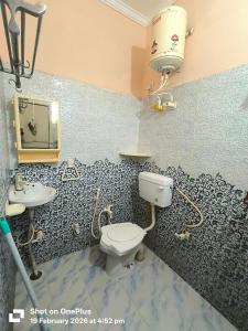 a bathroom with a toilet and a sink at Vraja Kishori Sewa Dham in Vrindāvan +15 photos