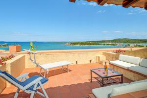 a patio with chairs and a table and the ocean at Marineledda la terrazza sul golfo in Santa Marinella