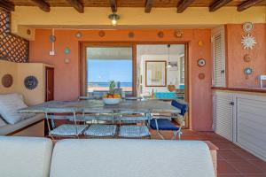 a dining room with a table and a view of the ocean at Marineledda la terrazza sul golfo in Santa Marinella +57 photos