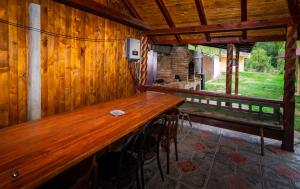 a long wooden table in a room with a fireplace at Ioska Boro in Mehadica