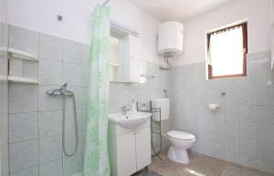 a bathroom with a toilet and a sink and a shower at Apartmani Suzi in Slatine +44 photos
