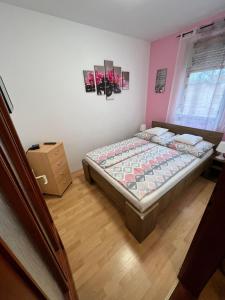 a bedroom with a bed in a room at Hellasz Apartman in Gyula
