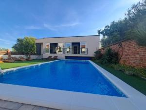 a swimming pool in the backyard of a house at Villa Nicoletta in Polača