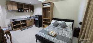 a small bedroom with a bed and a kitchen at JZA Staycation 1 in Mactan