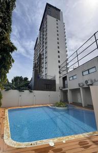 a swimming pool in front of a tall building at JZA Staycation 1 in Mactan