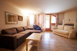 a living room with a couch and a table at Chesa Foulla Rosa - Celerina in Celerina