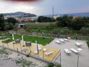a group of tables and chairs in a park at Villa Melina Bed & Breakfast in Agropoli +25 photos