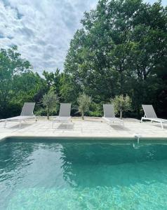a group of chairs and a swimming pool at Le tipi d'Hamih in Uzès