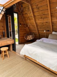 a bedroom with a bed and a table in a cabin at Le tipi d'Hamih in Uzès