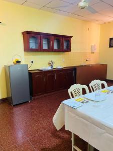 a room with two tables and a refrigerator at SAMA TOURIST guest in Seeduwa