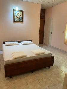 a bed in a room with two towels on it at SAMA TOURIST guest in Seeduwa +4 photos