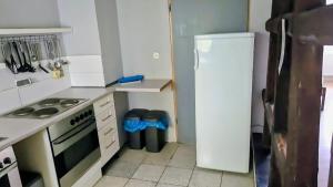 a kitchen with a white refrigerator and a stove at Monteurzimmer Nähe Pforzheim in Engelsbrand
