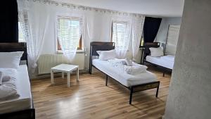 a living room with two beds and a table at Monteurzimmer Nähe Pforzheim in Engelsbrand