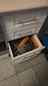 an open drawer in a desk with a remote control at Monteurzimmer Nähe Pforzheim in Engelsbrand