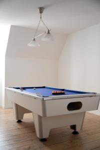 a pool table sitting on top of a wooden floor at Maison bourgeoise, Rives du Cher, 14 pers in Montrichard