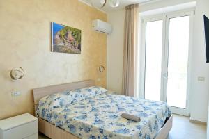 a bedroom with a bed in a room with a window at Villa Melina Bed & Breakfast in Agropoli