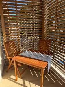 a wooden table and two chairs on a porch at Acquaviva Suites, Pool - View in San Vincenzo