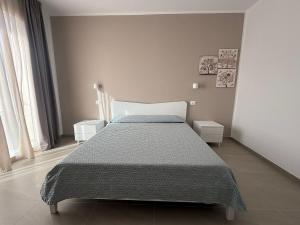 a bedroom with a bed and two night stands at Acquaviva Suites, Pool - View in San Vincenzo +16 photos
