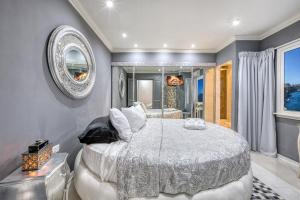 a bedroom with a large bed and a mirror at Charming City Stay close to Seafront in Birgu