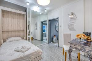 a bedroom with a bed and a table and a mirror at Charming City Stay close to Seafront in Birgu +37 photos