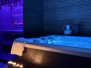 a blue bath tub in a room with a window at Luxauthentic villa with heated pool SALT STONE - sauna, jacuzzi, gym, outdoor kitchen with bbq in Mimice +50 photos