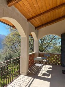 a patio with a table and chairs on a balcony at La Rosa di Tempalta in Roccadaspide