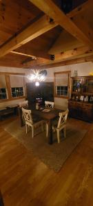 a dining room with a wooden table and chairs at Ohana cabin in Hanover