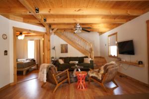a living room with a couch and a tv at Ohana cabin in Hanover