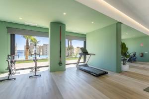 a gym with two treadmills and a treadmill at Sunset Cliffs Sol in Benidorm