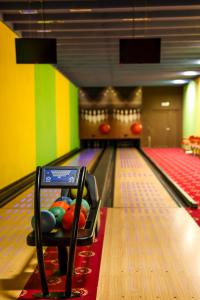 a bowling alley with a cart full of balls at Hotel Metro in Kłodzko