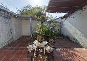a small table and chairs on a patio at Habitacion privada y central in Barranquilla