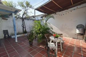 a patio with a table with fruit on it at Habitacion privada y central in Barranquilla