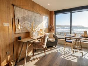 a home office with a desk and a table and chairs at The Boat House - Port Eynon in Swansea