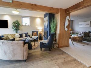 a living room with a couch and a table at The Boat House - Port Eynon in Swansea