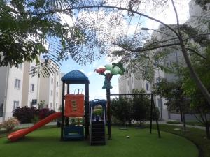 a playground with a slide in a park at NEW! Jungle Chic Retreat in Aldea Tulum in Tulum