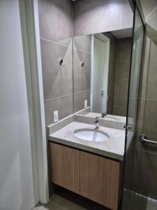 a bathroom with a sink and a mirror at Apto Stúdio Liberdade novíssimo in São Paulo +19 photos