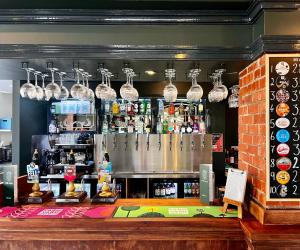 a bar with a counter and some glasses above it at The Bath Rooms in Morecambe