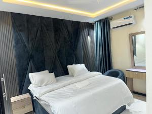 a hotel room with two beds and a mirror at Moor Times Hotel in Benin City